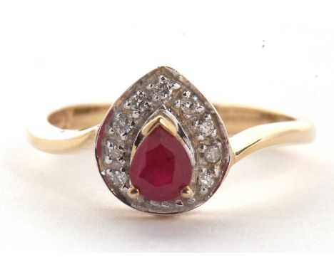 A 9ct ruby and diamond ring, the central pear shape ruby, claw mounted and surrounded by small round diamonds, with plain ban