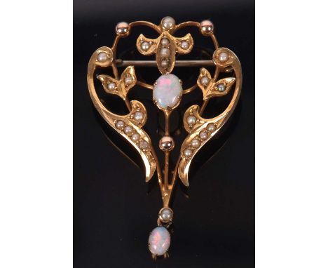 An Edwardian opal and seed pearl brooch, set to centre with an oval opal cabochon and another small drop below, with sprigs o