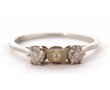 A diamond and 'pearl' ring, the central off-round 'pearl' set to either side with an old mine cut diamond and a European diam