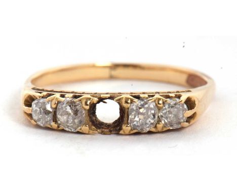 A diamond ring, set with four old mine cut diamonds (centre stone missing), all set in unmarked yellow metal (tests as approx