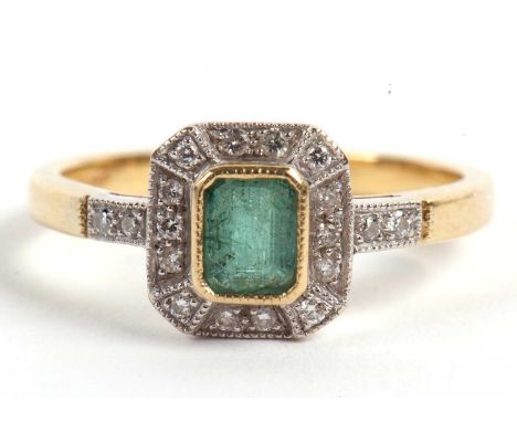 An 18ct emerald and diamond ring, the central step cut emerald surrounded by small round diamonds, diamond set shoulders, all