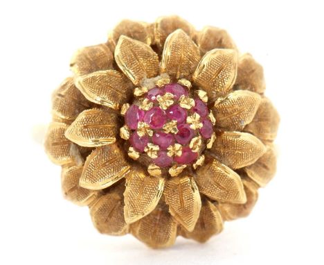 A 1960's 18ct and ruby flower ring, set to centre with small round rubies and surrounded by naturalistically modelled petals,
