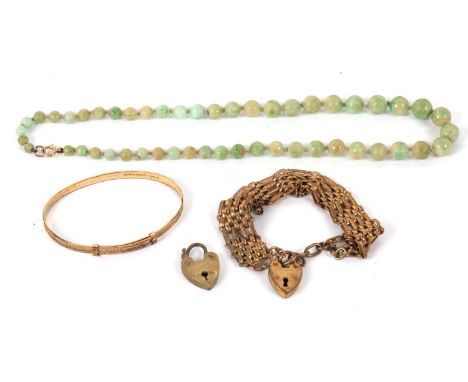 A green hardstone bead necklace with clasp stamped '9c', together with a gilt metal gate bracelet and an adjustable rolled go