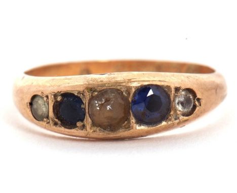 A 9ct sapphire and white stone ring, the alternating graduated sapphire and white stones in rubover mounts with closed backs,