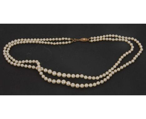 A cultured pearl necklace, the two graduated strands of round cultured pearls, with 9ct clasp hallmarked birmingham 1960, in 