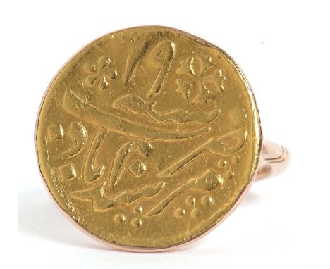 A Middle Eastern coin ring, the coin with a collet mount and plain band stamped 9ct, size L, 5.0g