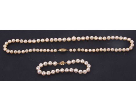 A cultured pearl necklace and bracelet, the slightly graduated cultured pearl necklace, 47cm long, with clasp stamped 375, to
