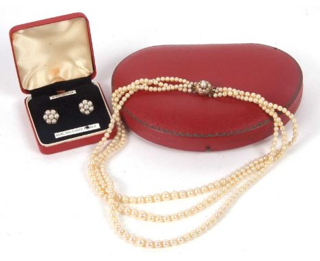 A cultured pearl necklace and matching earrings, the three strand graduated cultured pearl necklace with cluster clasp stampe