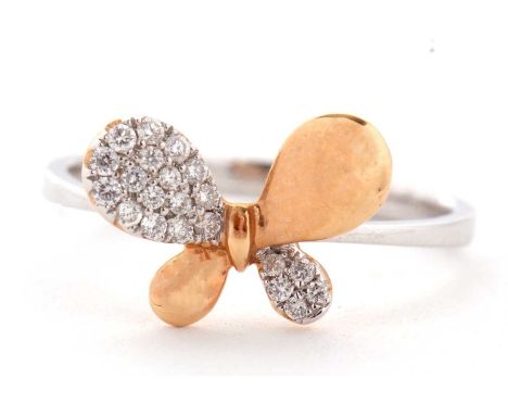 A two tone 18ct diamond butterfly ring, the wings alternately diamond pave and rose gold, to a plain band of white gold, stam