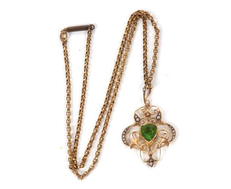 An Edwardian peridot pendant and gilt metal chain, the central heart shaped peridot set within a wirework frame with seed pea