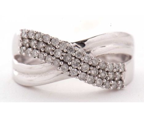 A 9kt diamond crossover ring, with three diamond set strands crossover and plain lower half, with tapered shoulders and plain