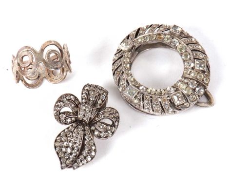 Three items of jewellery to include an early/mid 20th century round white paste set dress clip, indistinctly stamped 935, 35m