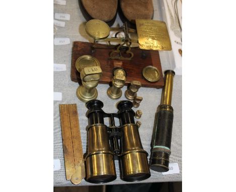 A selection of vintage brassware items including Post Office scales and binoculars 