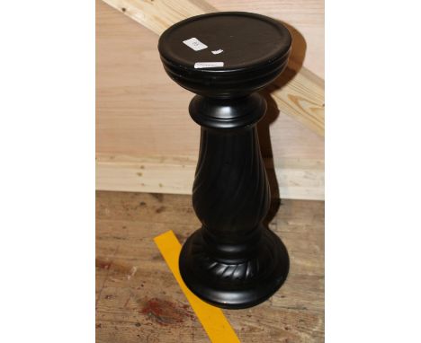 A black ceramic planter stand. postage unavailable 