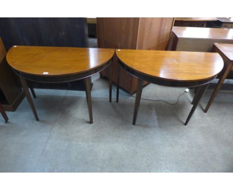 A pair of George III style mahogany demi lune console tables 