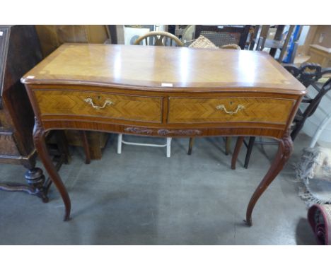 A French style inlaid mahogany two drawer serpentine console table 