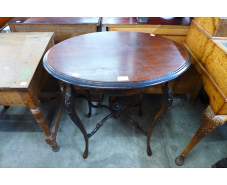 An Edward VII mahogany oval occasional table, labelled Popham Radford &amp; Co., Plymouth 