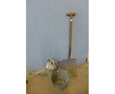 Two galvanised buckets, a watering can and a garden fork 
