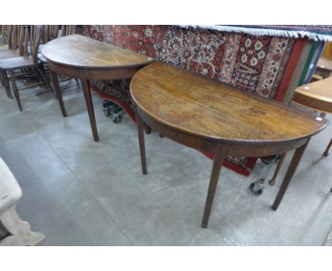 A pair of George III mahogany demi-lune console tables 