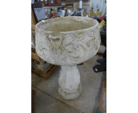 A concrete garden planter on stand 