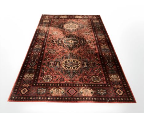 A machine made carpet of Afghan design, 300 cm x 202 cm 