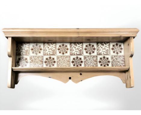 A pine wall shelf with tile inset back, width 70 cm.