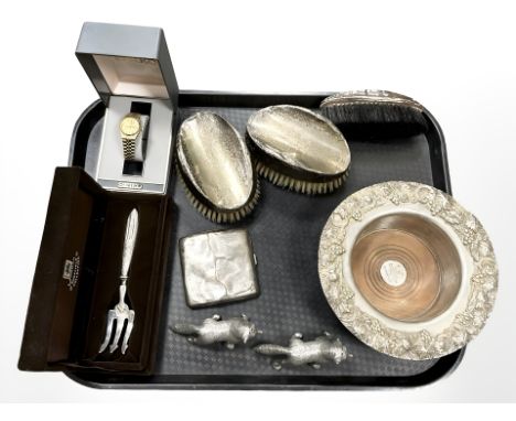 A group of silver-mounted dressing table brushes, a silver cigarette case, an ornate silver-plated bottle coaster, Seiko watc