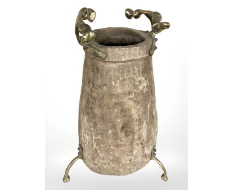 A rustic adzed wooden vase on brass tripod support with twin handles, height 65 cm.
