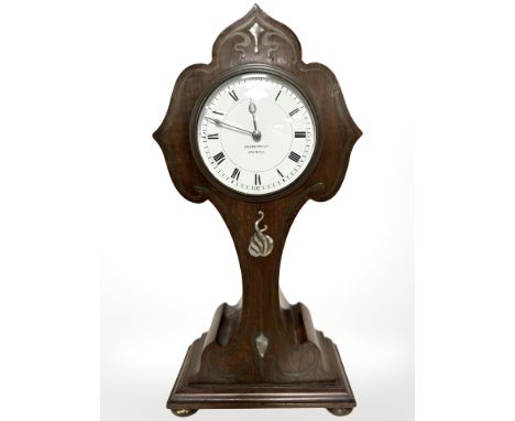 A mahogany and mother of pearl inlaid Art Nouveau mantel clock retailed by Goldsmiths, Newcastle, height 31 cm.