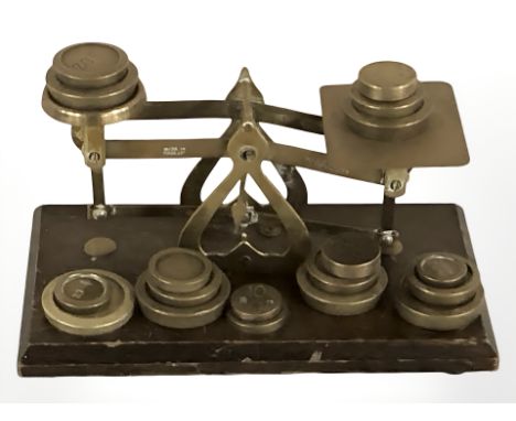 A set of Victorian brass letter scales with various weights.