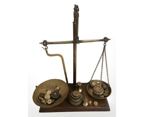 A set of mahogany and brass balance scales with various graduated weights, height 45 cm.