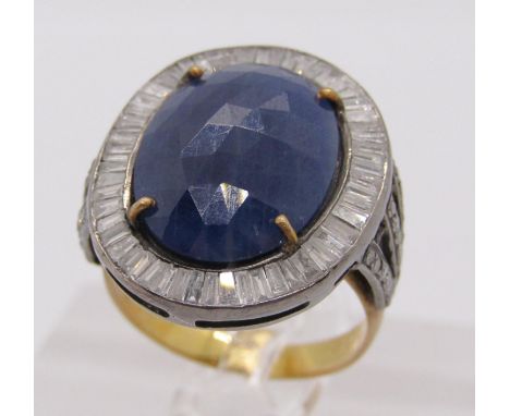 Bi-colour metal sapphire and diamond cluster dress ring, set with a large faceted opaque sapphire within baguette-cut diamond