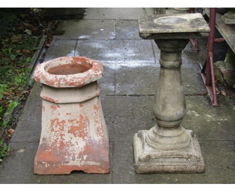 A weathered cast composition stone sundial pedestal of baluster form with scroll detail and square platform base, 66 cm high,