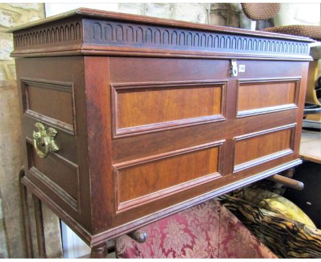 A walnut coffer with rectangular moulded panelled surround beneath a hinged lid with repeating arched moulded frieze and heav