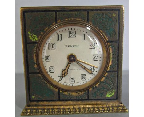 An art deco travelling clock in a brass case, the panelled case engraved with fish and weed, the movement with alarm by Zenit
