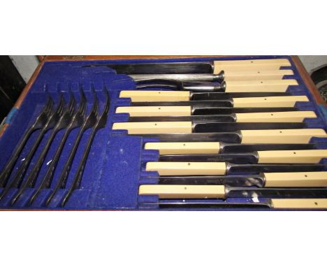 An early 20th century oak canteen with later stainless steel flatware and another  oak canteen of electro plated flatware wit