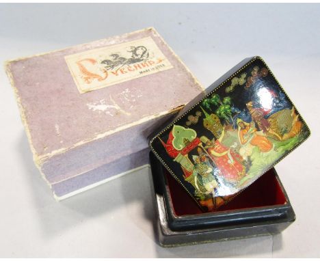 A papier-mâché lacquered box made in the USSR, signed and dated 1969, in its original box, 6cm wide, a rolled gold propelling