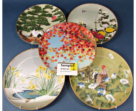 A collection of twelve Franklin Mint Japanese 'Birds and Flowers of the Orient' brightly coloured wall plates, each depicting