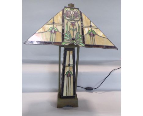 An Art Deco “Tiffany” style table lamp with a square floral ”lead” panelled shade set on a matching obelisk with brass suppor