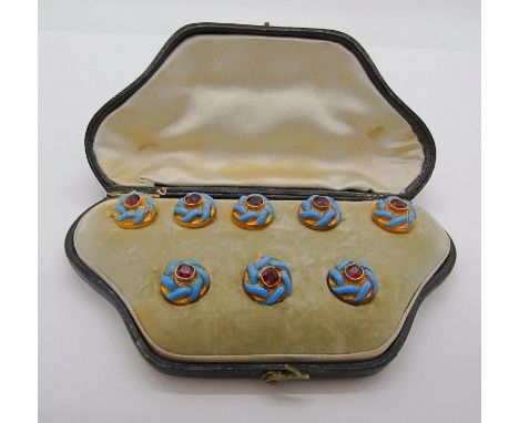 Cased set of antique yellow metal garnet dress jewellery with blue enamel detail, comprising five buttons and three studs (so