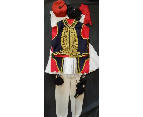 Greek traditional man's costume comprising braided waistcoat, white legwear, red sash, tasselled hat 