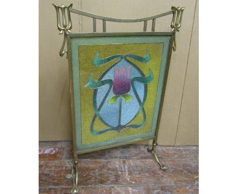An art nouveau firescreen in brass, the stylistic frame enclosing a glass bead work panel with central tulip 