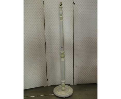 A turned wooden standard lamp with reeded and fluted stem, raised on a circular platform base with decorative painted finish,