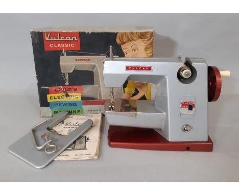 Vintage child's sewing machine 'Vulcan classic' with instructions, extension work table and clamp, in original box (untested)