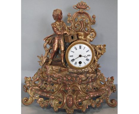 A Victorian gilded brass mantle clock in the romantic style enclosing a single train French movement with enamelled dial 