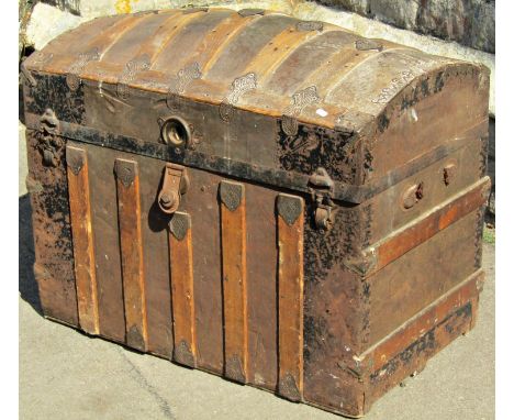 A late 19th century tin lathe overlay travelling trunk with domed lid, 