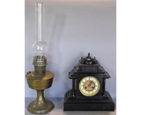 A Victorian black slate mantel clock of classical design, together with an oil lamp with twin burning wick 