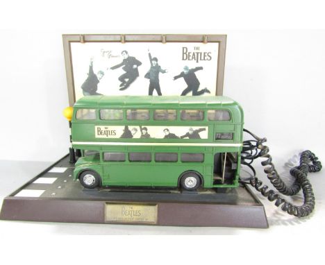 Beatles memorabilia in the form of green No 77 double decker bus telephone stopped in front of The Abbey Road Zebra Crossing,