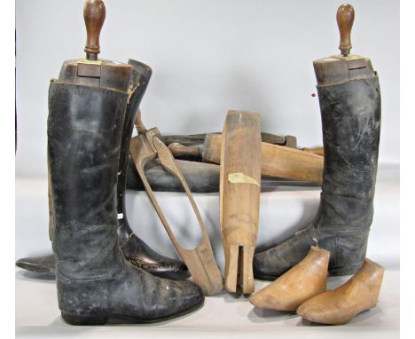 A pair of vintage black riding boots with wooden trees and an assortment of other boot trees, (as found) 