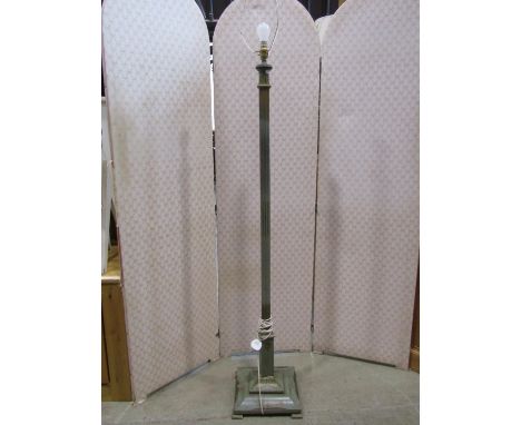 An early 20th century wooden standard lamp with fluted column raised on a square stepped cushion base with decorative all ove